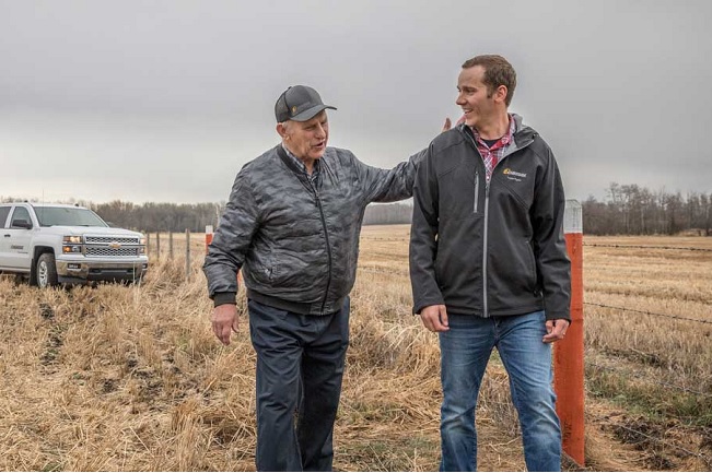 Farmer and land agent on pipeline right of way