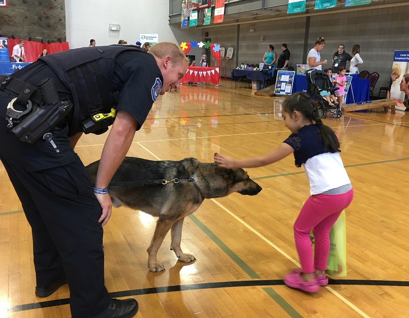 Little girl with autism petting a dog