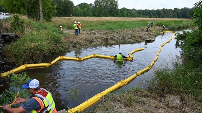 Workers deployed inflatable containment boom during the full-scale exercise