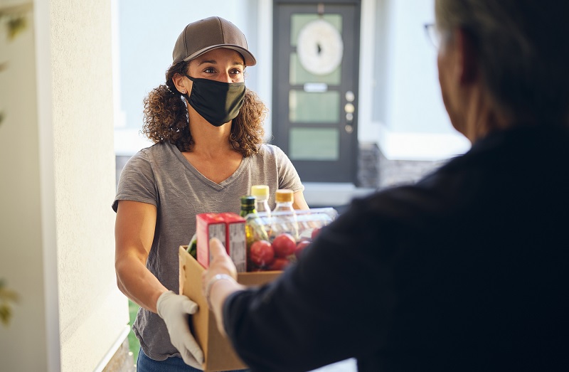 Woman handing off a hamper of food