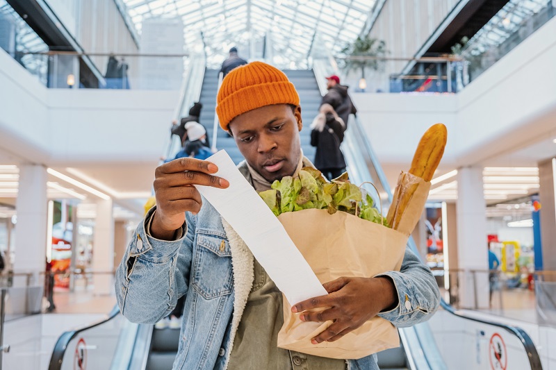 Man looking at grocery bill