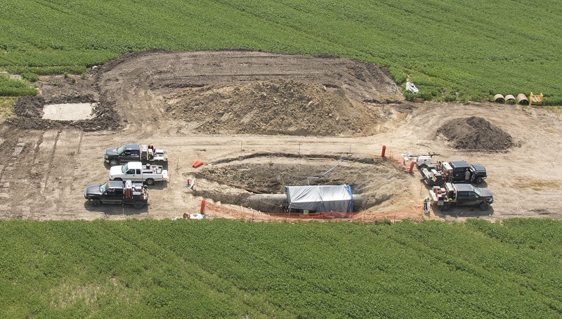 Crews digging around an underground pipe