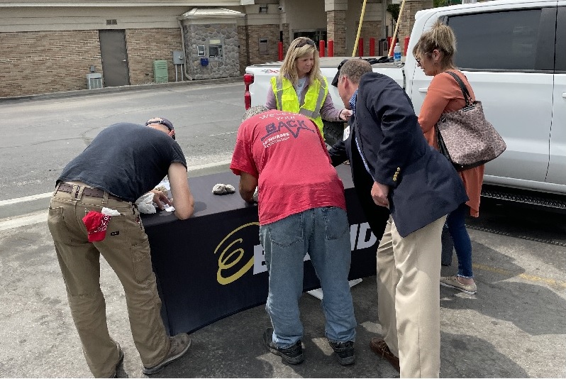 People writing at Enbridge stand
