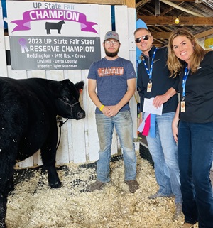 Teenage 4-H winner with a steer