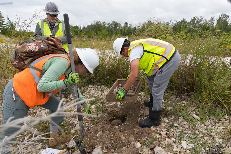 Three workers digging