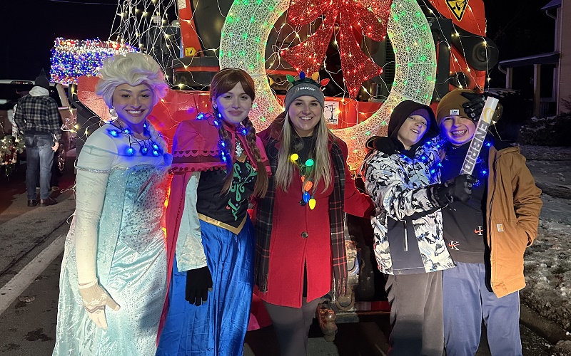 People standing with a Christmas parade