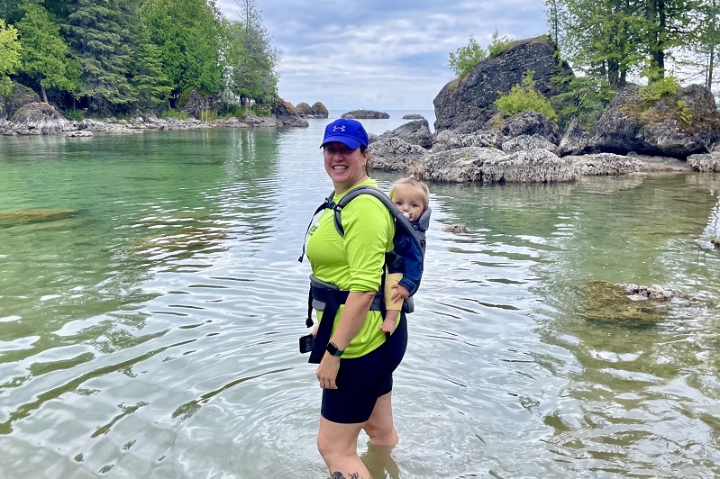 Mother and daughter stand in lake 