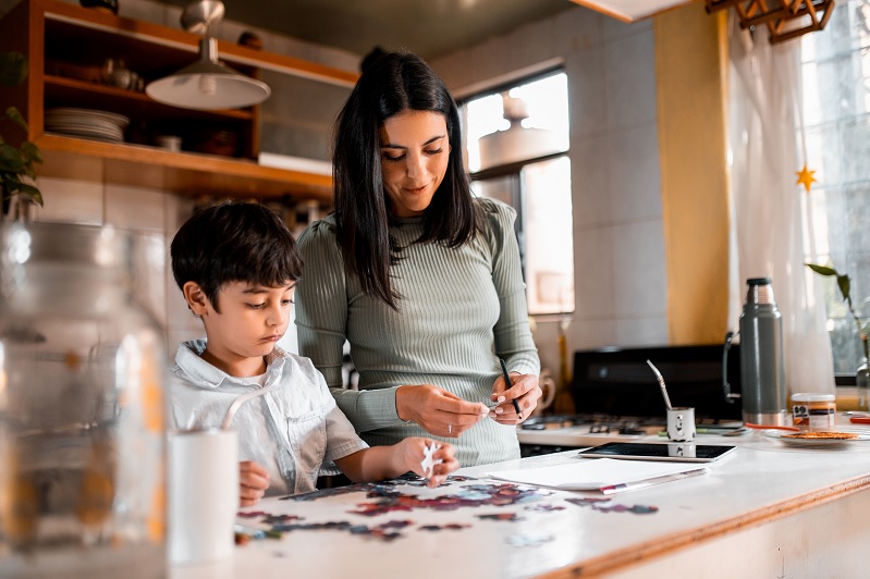 Adult and child build puzzle