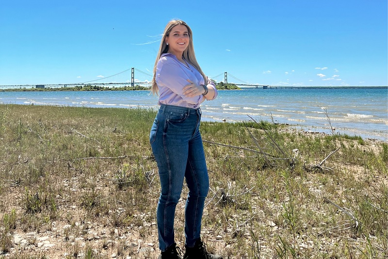 Girl standing in front of body of water