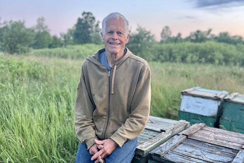 Photo of man sitting in a field