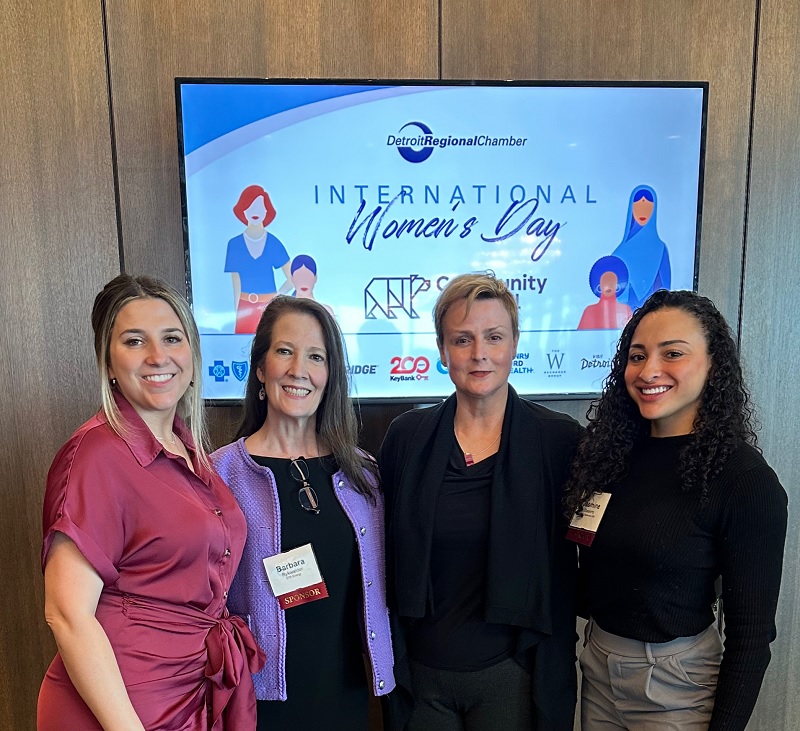 Four women in front of a TV screen