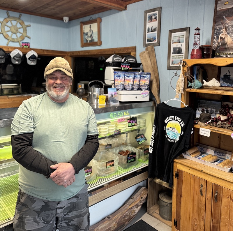 Man standing in store in front of counter
