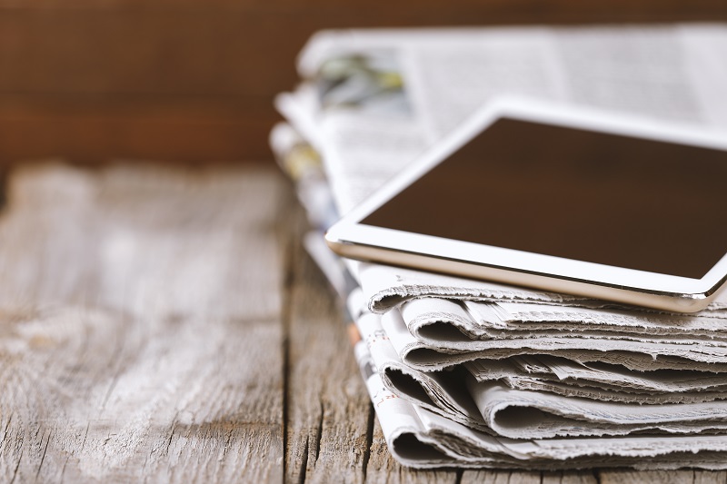 Newspapers and digital tablet