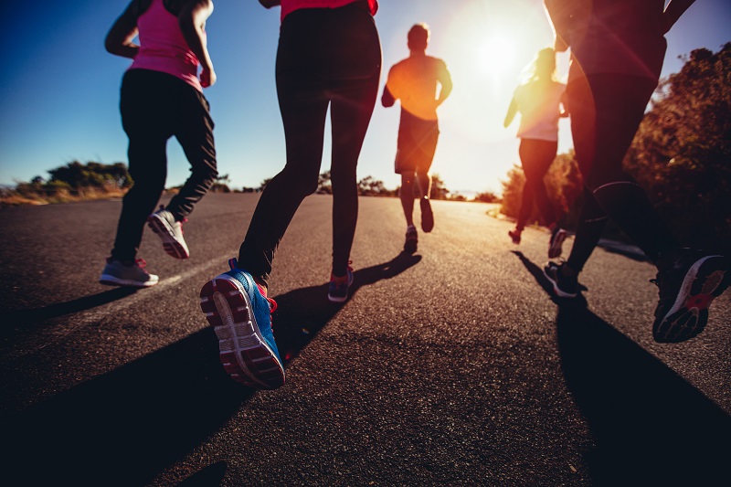Group of people jogging at sunset