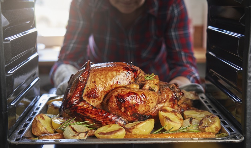 Taking a turkey out of the oven