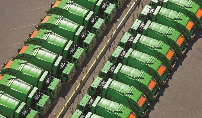 Aerial view of rows of garbage trucks