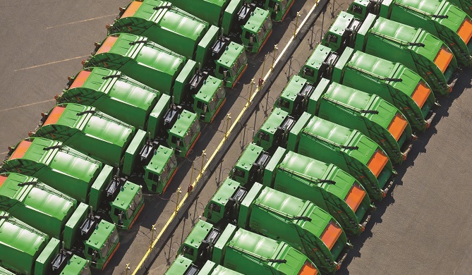 Aerial view of rows of garbage trucks