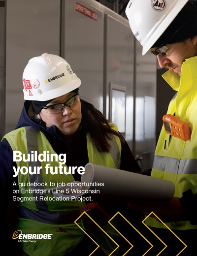 Two people in hardhats and safety vests