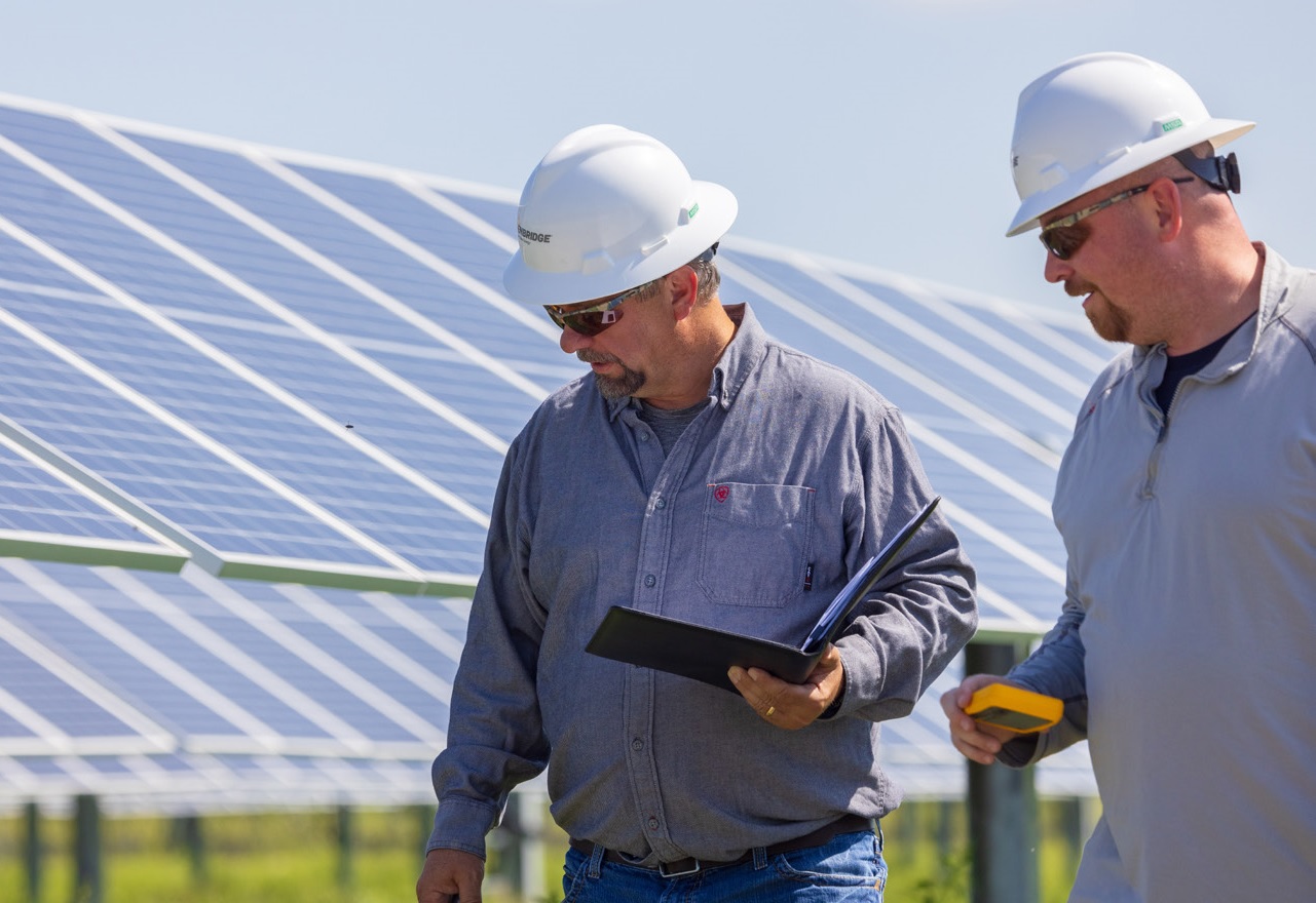 Workers at a solar energy facility