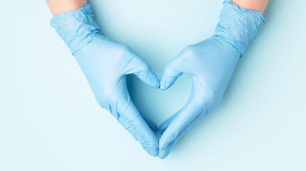 Doctor's medical gloves forming a heart