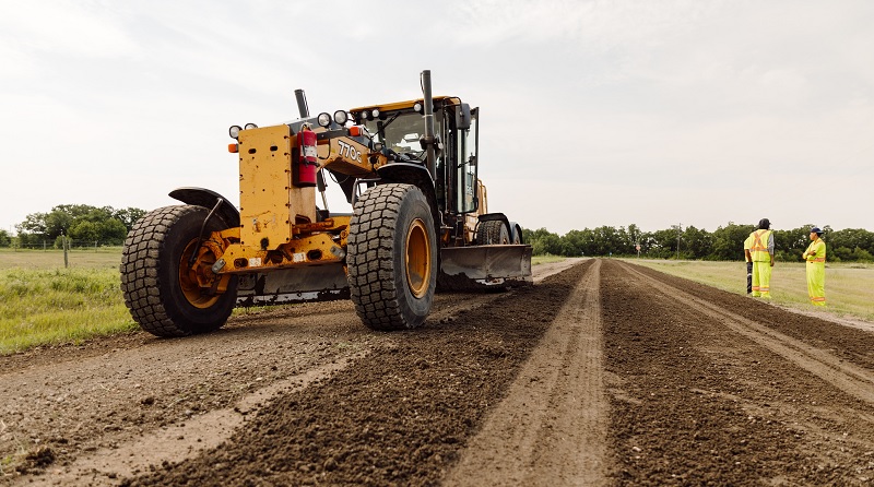 Grader working on gravel road