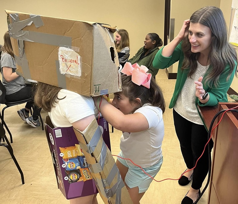 Girl in a robot costume in a classroom