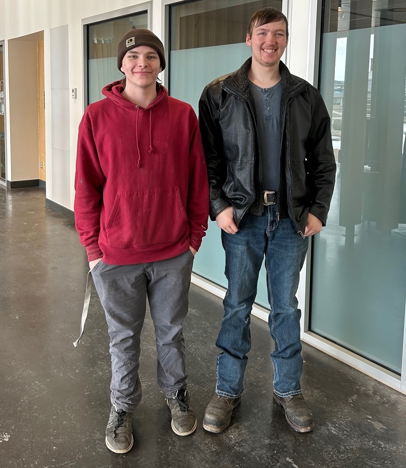 Two young men in a college hallway