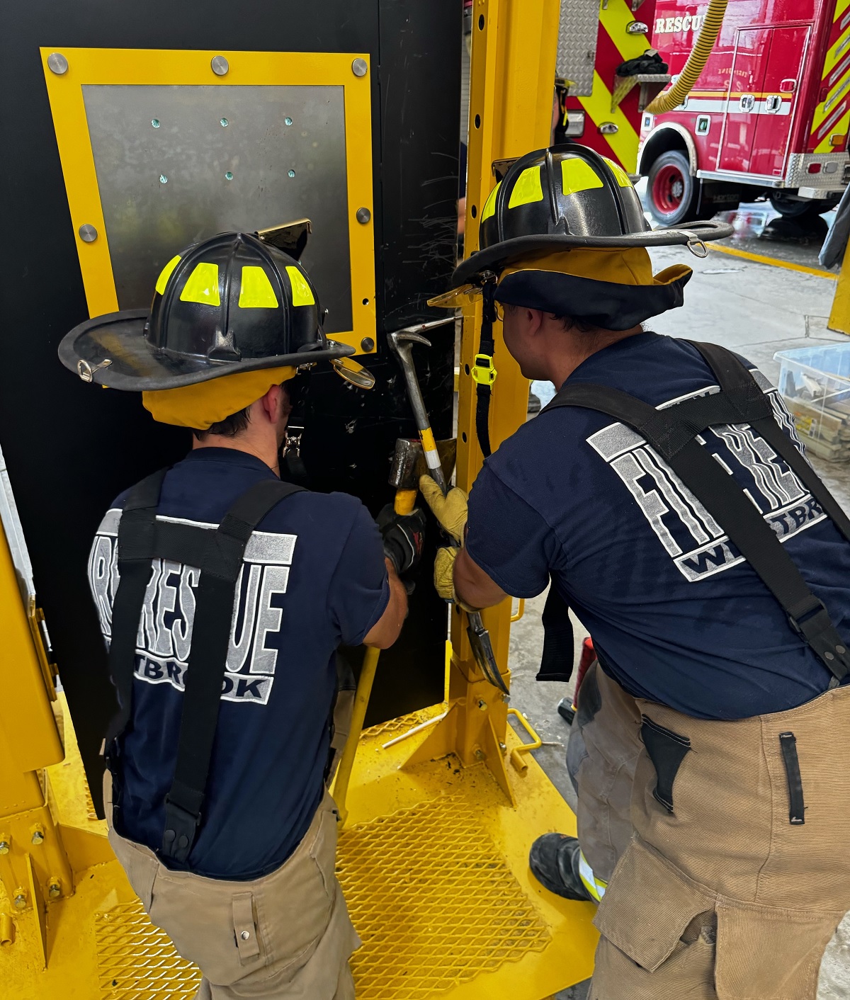 Firefighters at a practice entry door