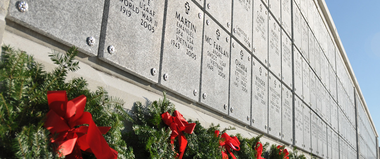 line of graves of fallen soldiers with wreaths below