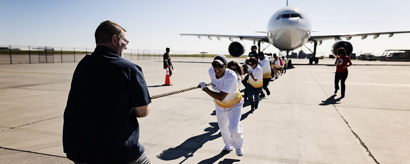 People pulling a plane by rope
